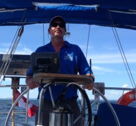 Owner, Bill at the helm of his boat.